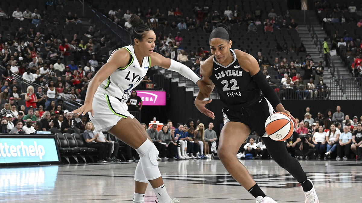 Las Vegas Aces center A'ja Wilson (22) drives past Minnesota Lynx forward Napheesa Collier (24) in the first quarter of their game at T-Mobile Arena.