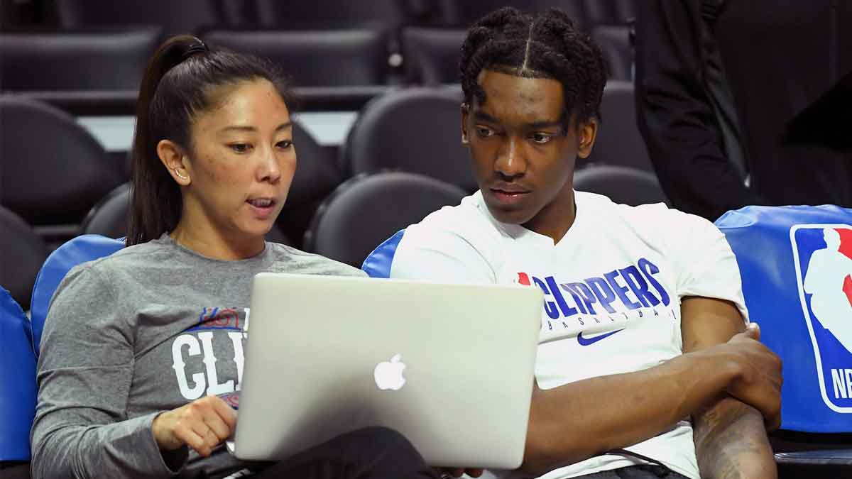 Los Angeles Clippers guard Terance Mann (right) talks with player development assistant coach Natalie Nakase before a game against the Philadelphia 76ers at Staples Center. 