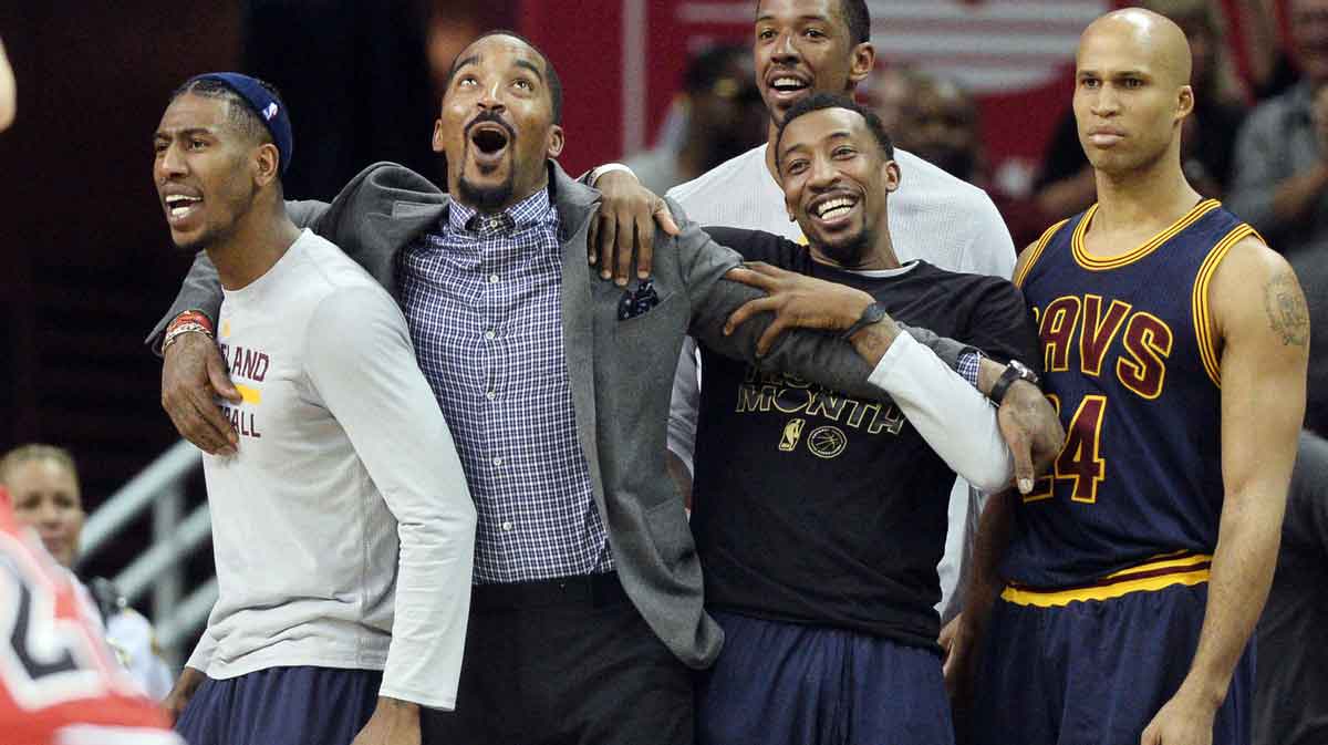 Cleveland Cavaliers guard Iman Shumpert (4) and guard J.R. Smith (5) and guard Jordan McRae (12) and forward Richard Jefferson (24) react to a replay of Cleveland Cavaliers forward Derrick Williams' dunk during the first half against the Chicago Bulls at Quicken Loans Arena.