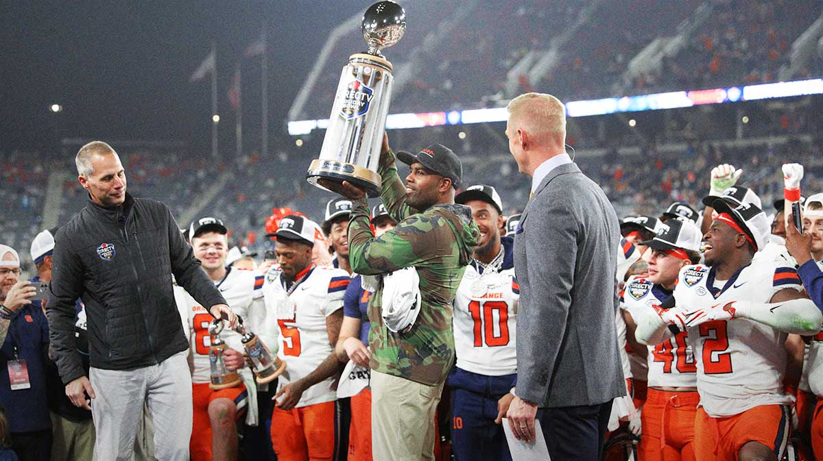 Syracuse Orange head coach Fran Brown raises the Holiday Bowl trophy after defeating the Washington State Cougars after the game at Snapdragon Stadium.