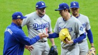 Los Angeles Dodgers manager Dave Roberts (30) takes the ball from pitcher Roki Sasaki (11) in the ninth inning during game one of the NLCS round against the Milwaukee Brewers for the 2025 MLB playoffs at American Family Field.