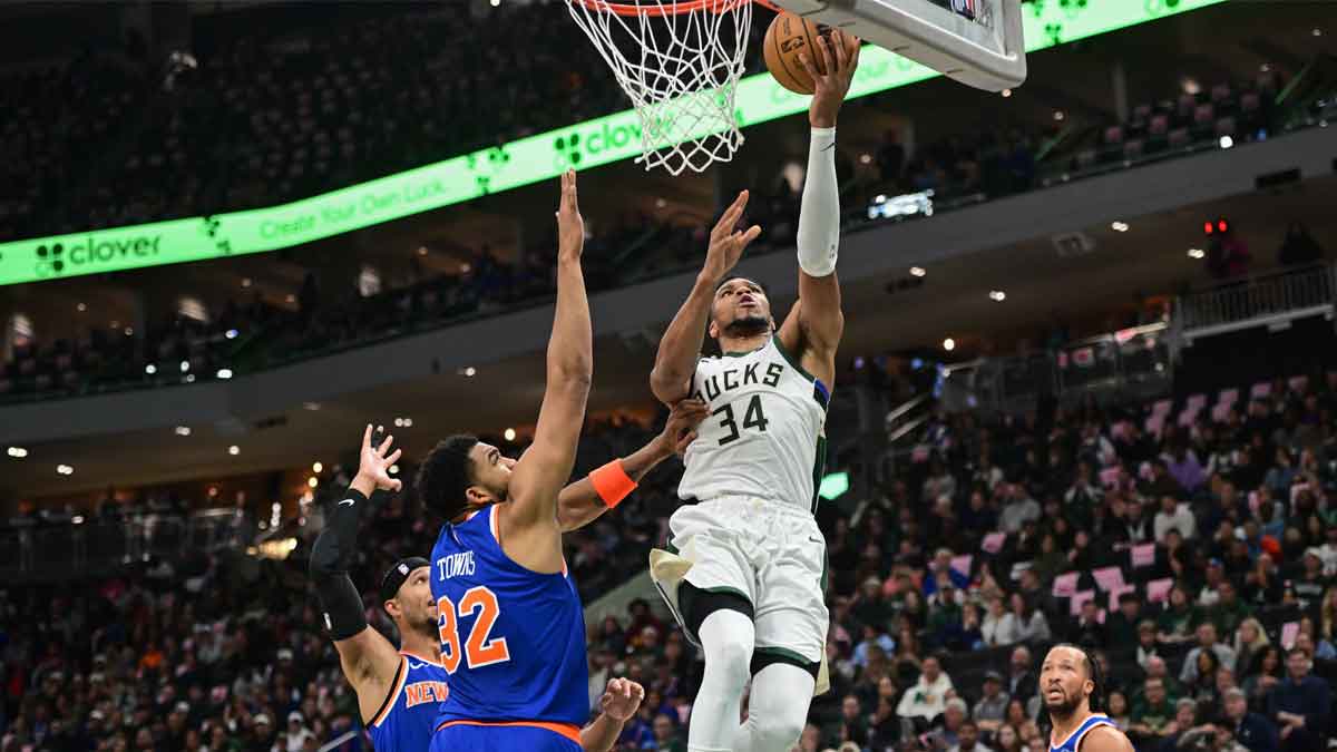 Milwaukee Bucks forward Giannis Antetokounmpo (34) takes a shot against New York Knicks center Karl-Anthony Towns (32) in the second quarter at Fiserv Forum.