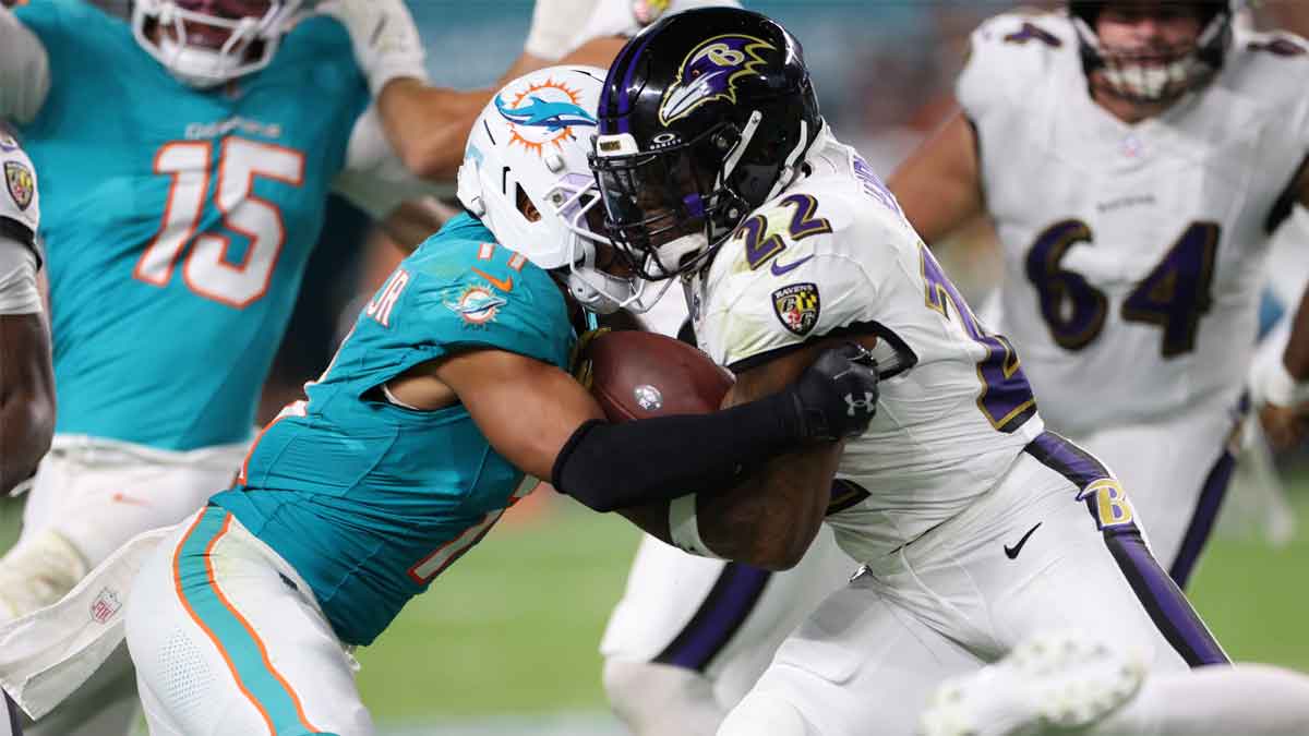 Baltimore Ravens running back Derrick Henry (22) is tackled by Miami Dolphins safety Dante Trader Jr. (11) during the second quarter at Hard Rock Stadium.