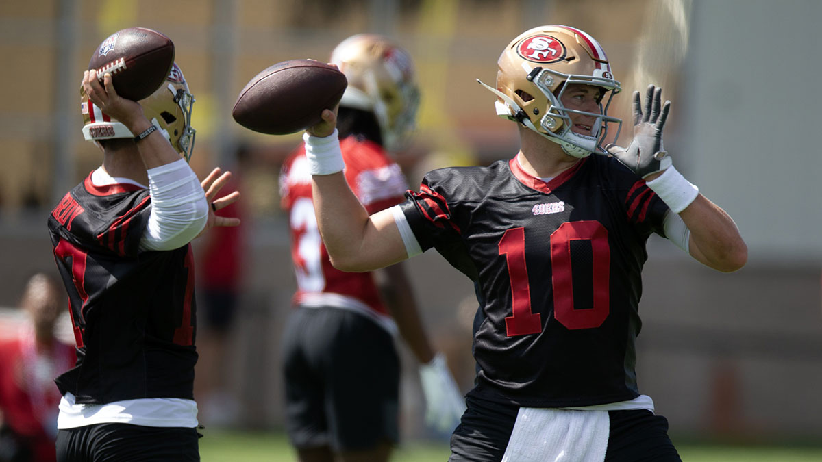 San Francisco 49ers quarterbacks Brock Purdy (13) and Mac Jones (10) work on passing drills during the first day of training camp at SAP Performance Facility.