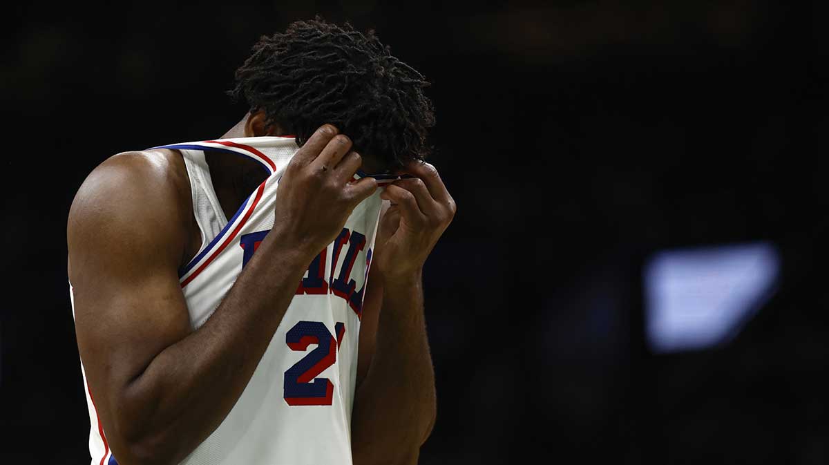 Philadelphia 76ers center Joel Embiid (21) wipes sweat from his face during the second quarter against the Boston Celtics at TD Garden.