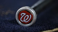 A detailed view of the Washington Nationals logo on a weighted bat during the seventh inning of the game between the Washington Nationals and the New York Mets at Nationals Park.