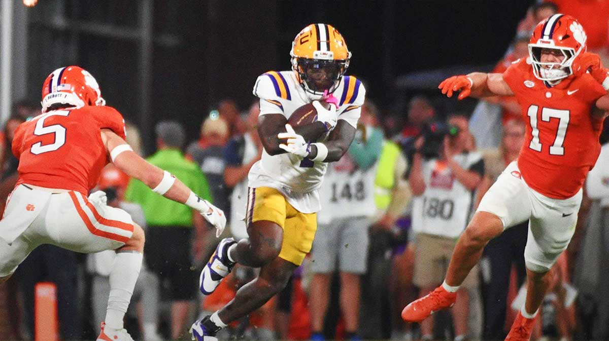 Clemson Tigers defensive back Ronan Hanafin (5) and Clemson Tigers linebacker Wade Woodaz (17) go to tackle LSU Tigers wide receiver Aaron Anderson (1)