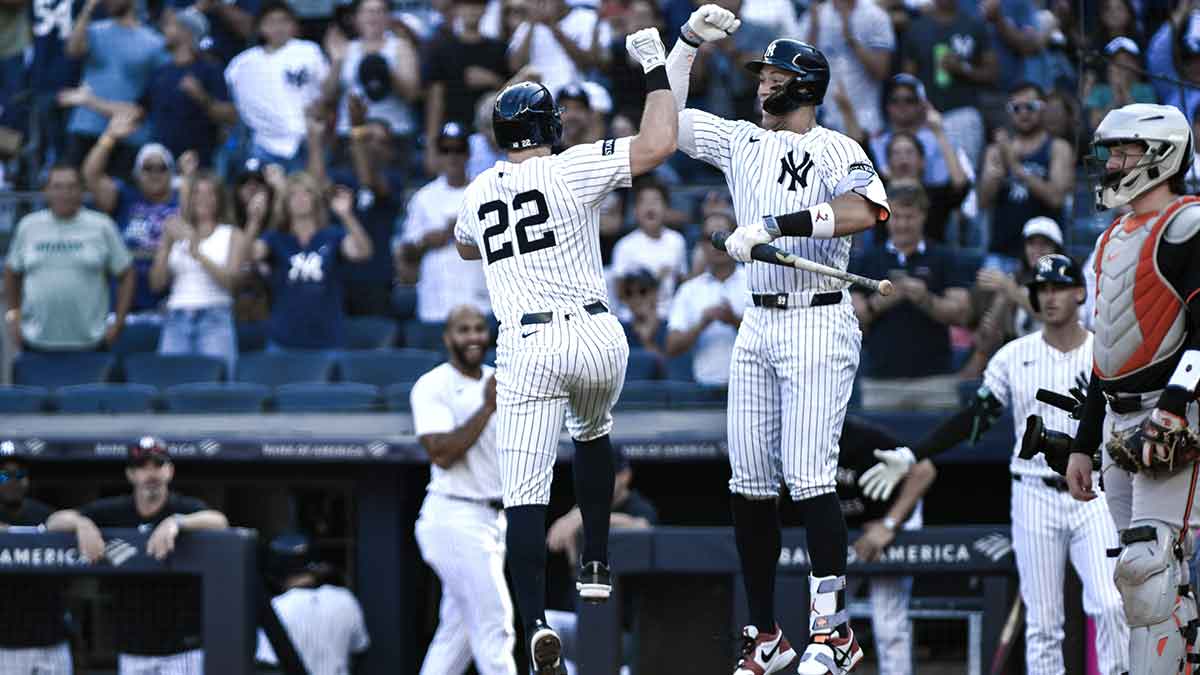 New York Yankees first baseman Ben Rice (22) celebrates at home plate with outfielder Aaron Judge (99) after hitting a solo home run against the Baltimore Orioles during the first inning at Yankee Stadium.