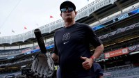 New York Yankees manager Aaron Boone (17) watches batting practice before game one of the Wildcard round of the 2025 MLB playoffs against the Boston Red Sox at Yankee Stadium.