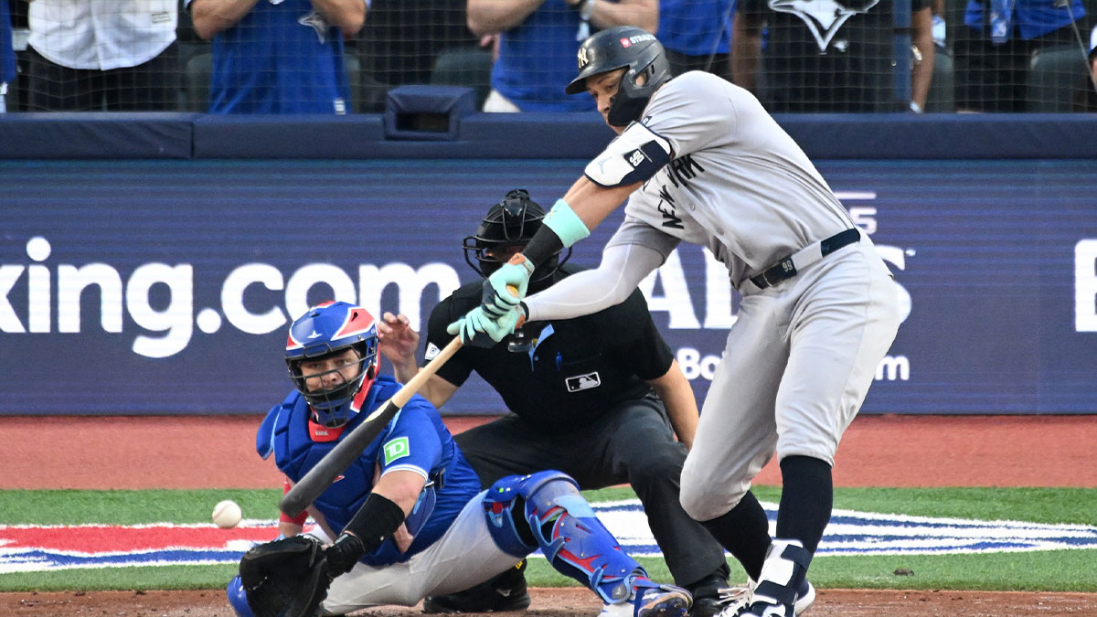 New York Yankees right fielder Aaron Judge (99) strikes out in front of Toronto Blue Jays catcher Alejandro Kirk (30) in the sixth inning during game one of the ALDS round for the 2025 MLB playoffs at Rogers Centre.