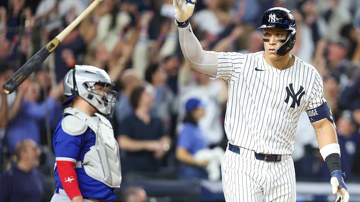New York Yankees outfielder Aaron Judge (99) flips his bat after hitting a three-run home run in the fourth inning against the Toronto Blue Jays during game three of the ALDS round for the 2025 MLB playoffs at Yankee Stadium.