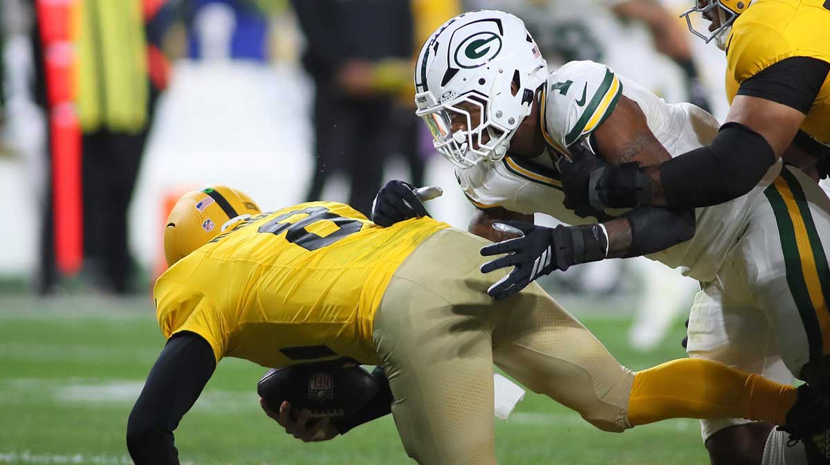 Pittsburgh Steelers quarterback Aaron Rodgers (8) gets sacked by Green Bay Packers defensive end Micah Parsons (1) during the second half at Acrisure Stadium in Pittsburgh, PA on October 26, 2025.