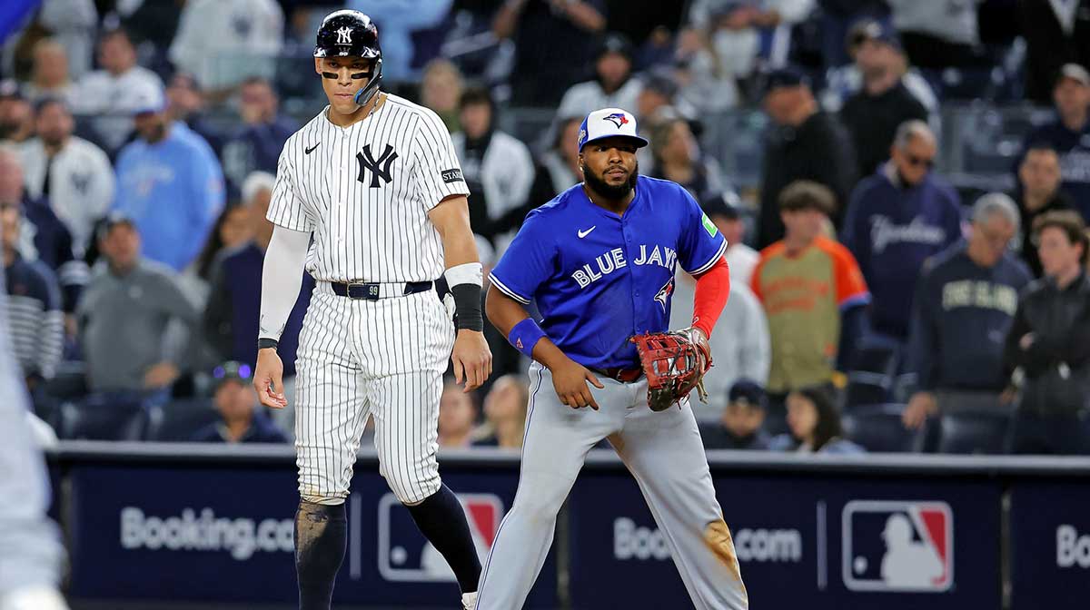 New York Yankees right fielder Aaron Judge (99) stands on first base with Toronto Blue Jays first baseman Vladimir Guerrero Jr. (27) during the ninth inning during game four of the ALDS round for the 2025 MLB playoffs at Yankee Stadium