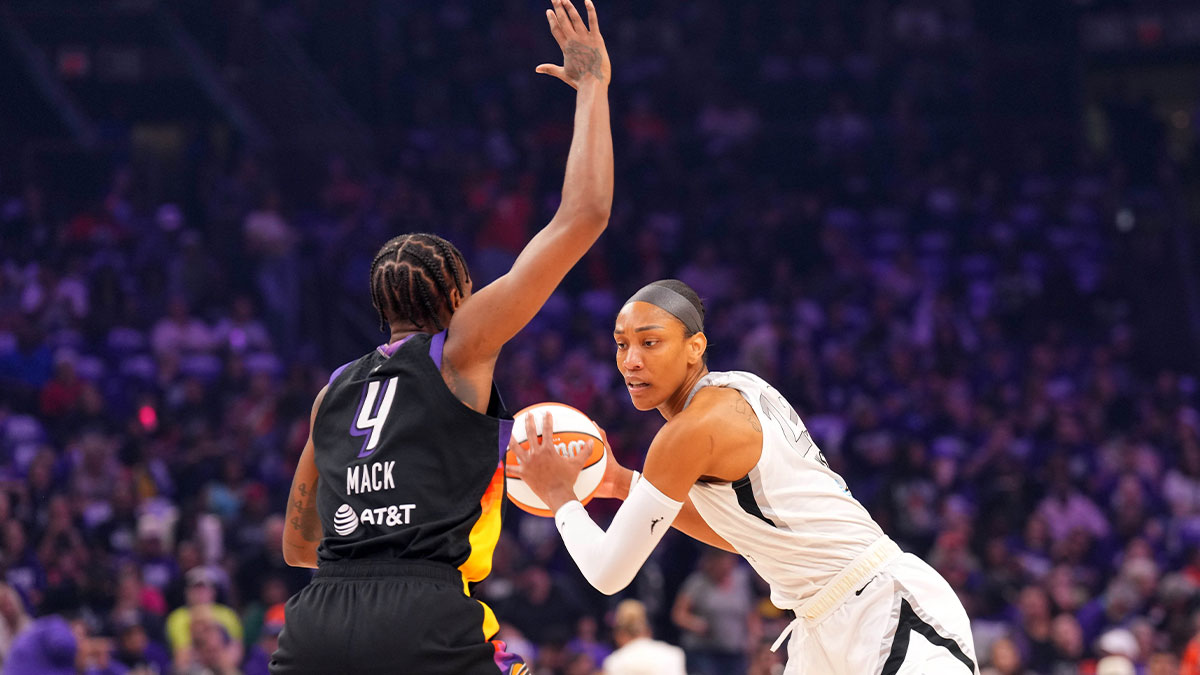 Las Vegas Aces center A'ja Wilson (22) dribbles against Phoenix Mercury forward Natasha Mack (4) during the first half of game four of the 2025 WNBA Finals at Mortgage Matchup Center.