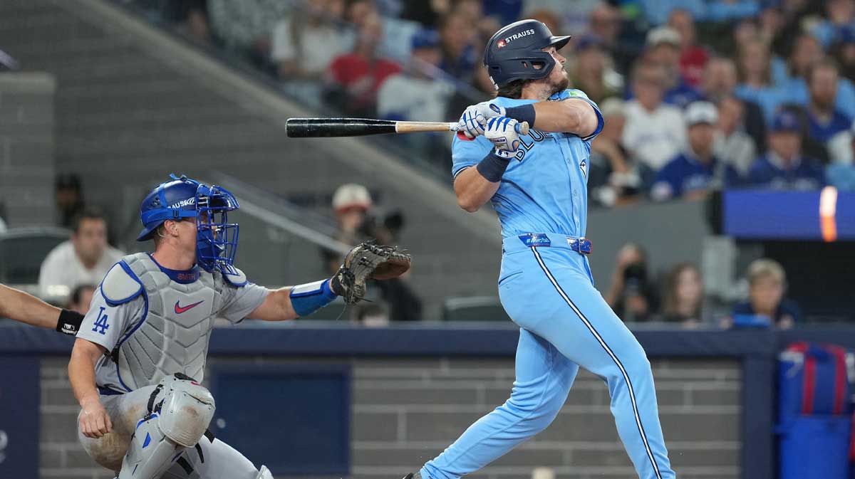 Toronto Blue Jays third baseman Addison Barger (47) hits a double against the Los Angeles Dodgers in the third inning for game six of the 2025 MLB World Series at Rogers Centre.