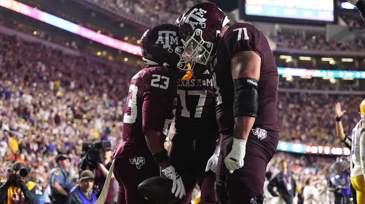 Texas A&M Aggies running back Jamarion Morrow (23) celebrates with offensive lineman Chase Bisontis (71) and tight end Theo Melin Ohrstrom (17) after a touchdown during the second half against the Louisiana State Tigers at Tiger Stadium.