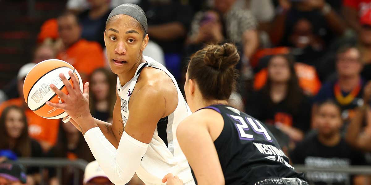 Las Vegas Aces center A'ja Wilson (22) attempts to dribble the ball past Phoenix Mercury forward Kathryn Westbeld (24) in the second half during game three of the 2025 WNBA Finals at PHX Arena.