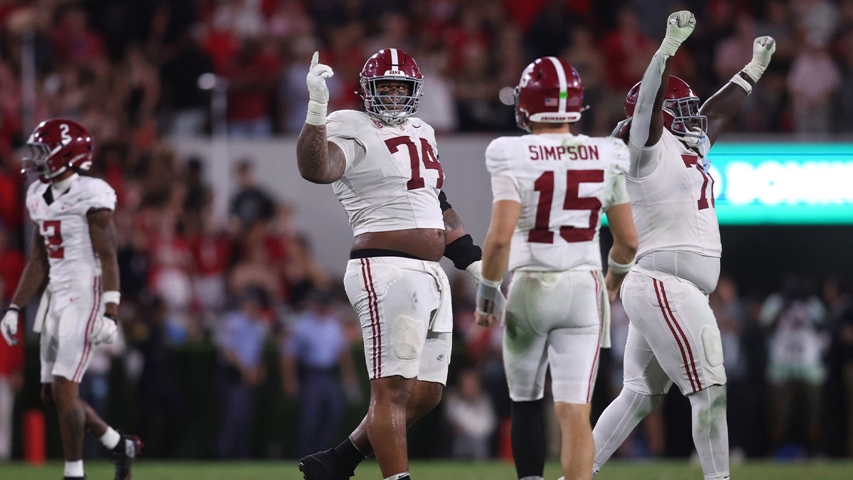 Alabama Crimson Tide offensive lineman Kadyn Proctor (74) celebrates with quarterback Ty Simpson (15) after defeating the Georgia Bulldogs at Sanford Stadium.