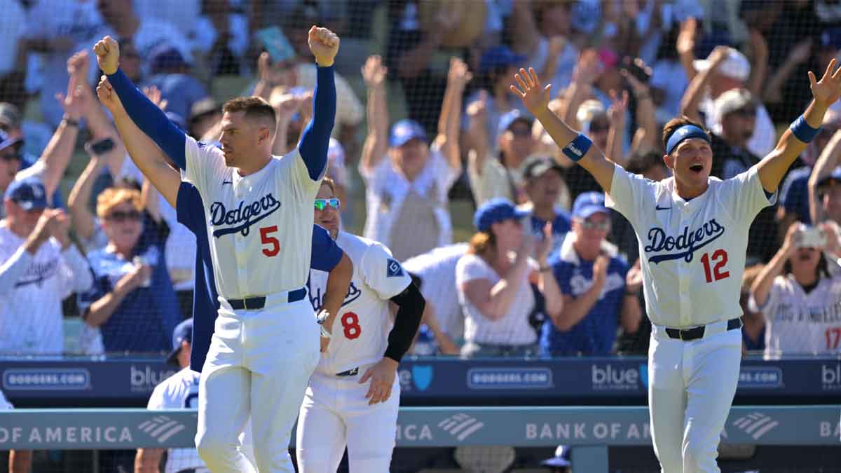 Los Angeles Dodgers first baseman Freddie Freeman (5), left fielder Enrique Hernandez (8) and right fielder Alex Call (12) celebrate after catcher Will Smith (16) hit a walk-off home run in the ninth inning against the Arizona Diamondbacks at Dodger Stadium.