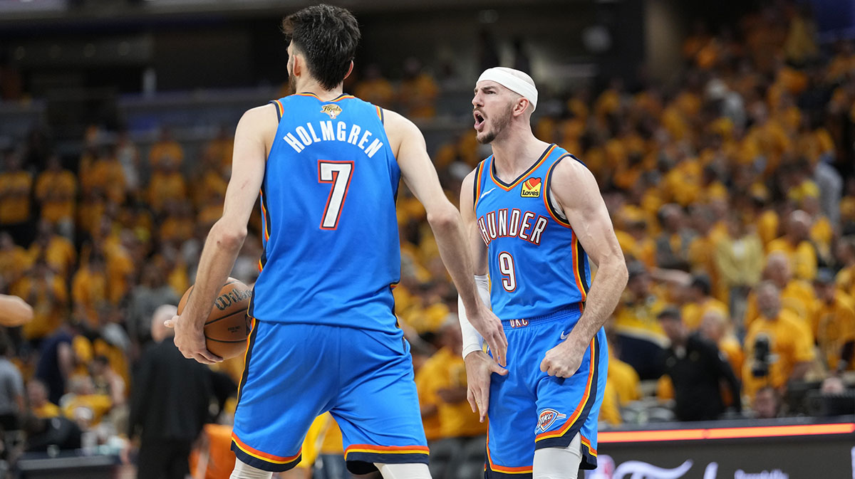 Oklahoma City Thunder guard Alex Caruso (9) and forward Chet Holmgren (7) react after defeating the Indiana Pacers in game four of the 2025 NBA Finals at Gainbridge Fieldhouse.