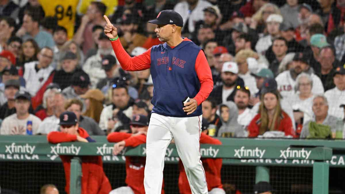Boston Red Sox manager Alex Cora (21) signals to the bullpen during the fifth inning against the Athletics at Fenway Park.