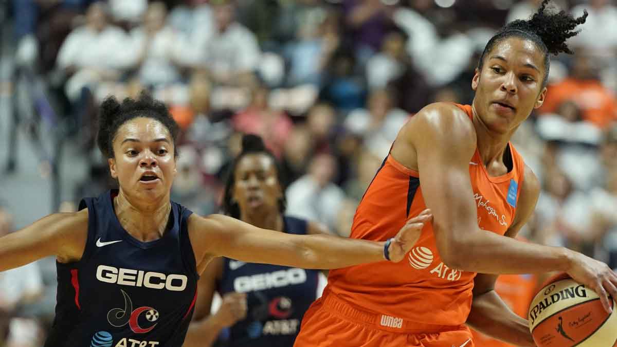 Connecticut Sun forward Alyssa Thomas (25) holds the ball against Washington Mystics guard Kristi Toliver (20) during the second quarter in game three of the 2019 WNBA Finals at Mohegan Sun Arena.