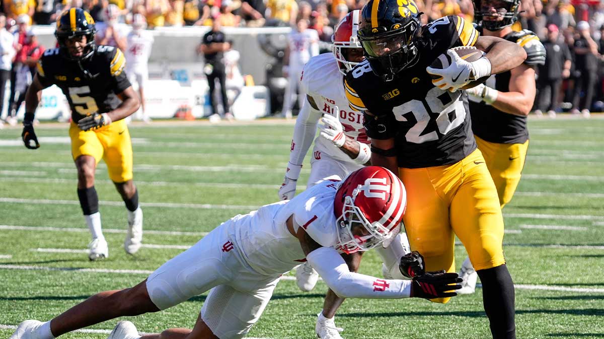 Iowa Hawkeyes running back Kamari Moulton (28) is tackled by Indiana Hoosiers defensive back Amare Ferrell (1) Sept. 27, 2025 at Kinnick Stadium in Iowa City, Iowa.