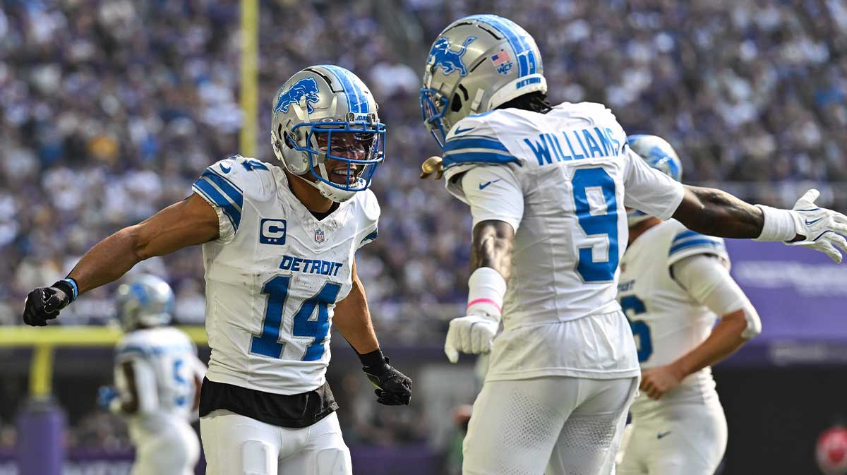 Detroit Lions wide receiver Amon-Ra St. Brown (14) reacts with wide receiver Jameson Williams (9) after catching a 35 yard touchdown pass from quarterback Jared Goff (not pictured) against the Minnesota Vikings the second quarter at U.S. Bank Stadium.