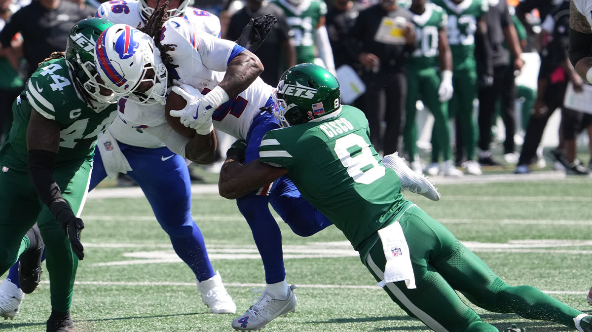 Buffalo Bills running back James Cook (4) is tackled by New York Jets safety Andre Cisco (8) during the first half at MetLife Stadium.