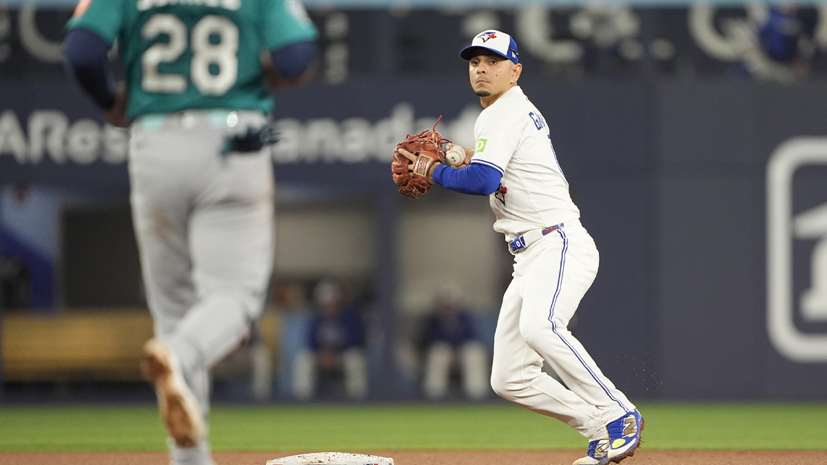 Toronto Blue Jays second baseman Andres Gimenez (0) makes a throw to first for a double play against Seattle Mariners third baseman Eugenio Suarez (28) and shortstop J.P. Crawford (not pictured) in the fourth inning during game six of the ALCS round for the 2025 MLB playoffs at Rogers Centre.