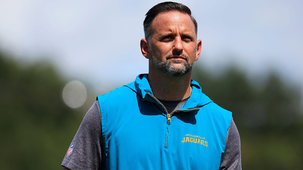 Jacksonville Jaguars defensive coordinator Anthony Campanile walks off the field to be interviewed by media members after an NFL training camp session at the Miller Electric Center, Thursday, Aug. 14, 2025 in Jacksonville, Fla.