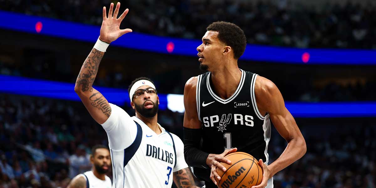 San Antonio Spurs forward Victor Wembanyama (1) looks to shoot Dallas Mavericks forward Anthony Davis (3) defends during the second half at American Airlines Center.