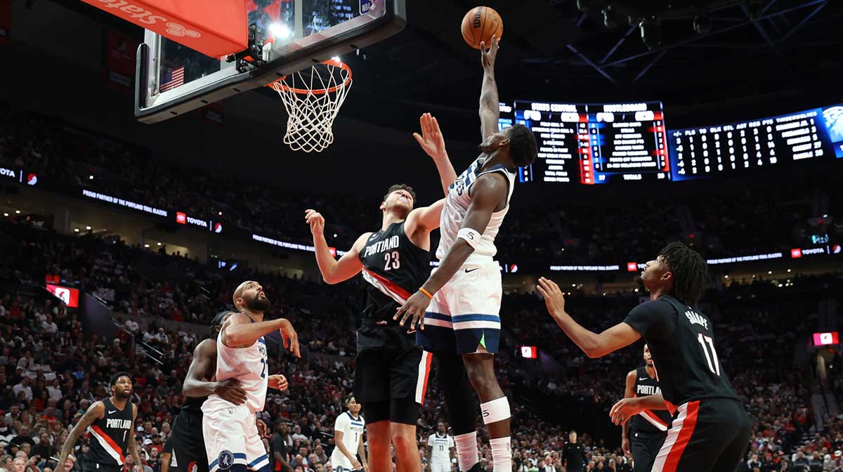 Minnesota Timberwolves guard Anthony Edwards (5) shoots the ball over Portland Trail Blazers center Donovan Clingan (23) in the first half at Moda Center.