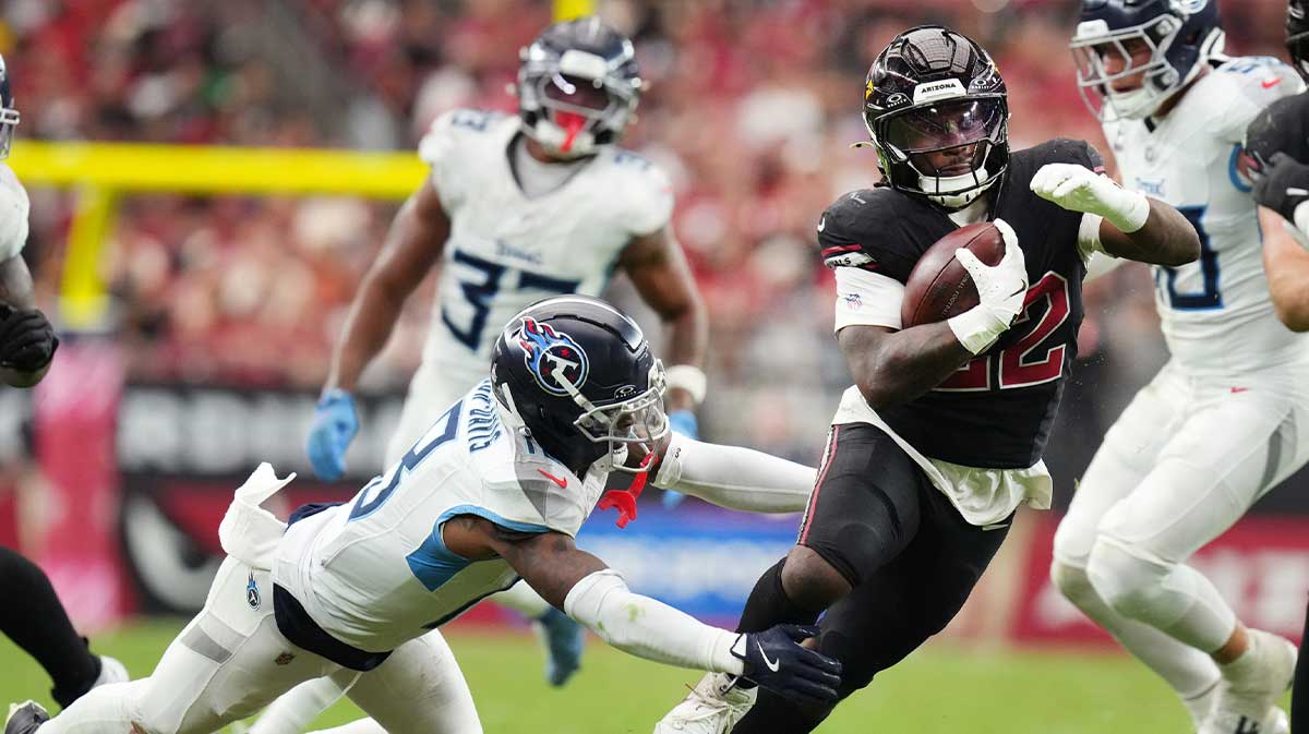 Arizona Cardinals running back Michael Carter (22) jukes by Tennessee Titans cornerback Jalyn Armour-Davis (18) 