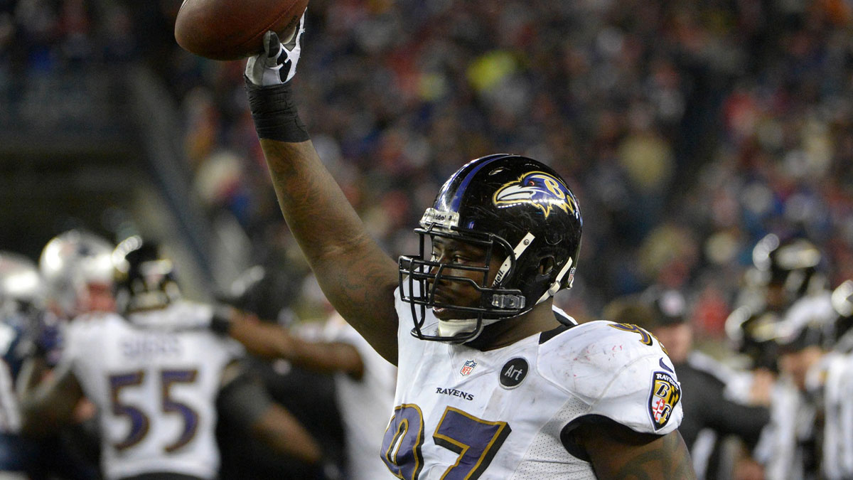 Baltimore Ravens defensive end Arthur Jones (97) celebrates after recovering a fumble in the fourth quarter against the New England Patriots during the AFC championship game at Gillette Stadium.
