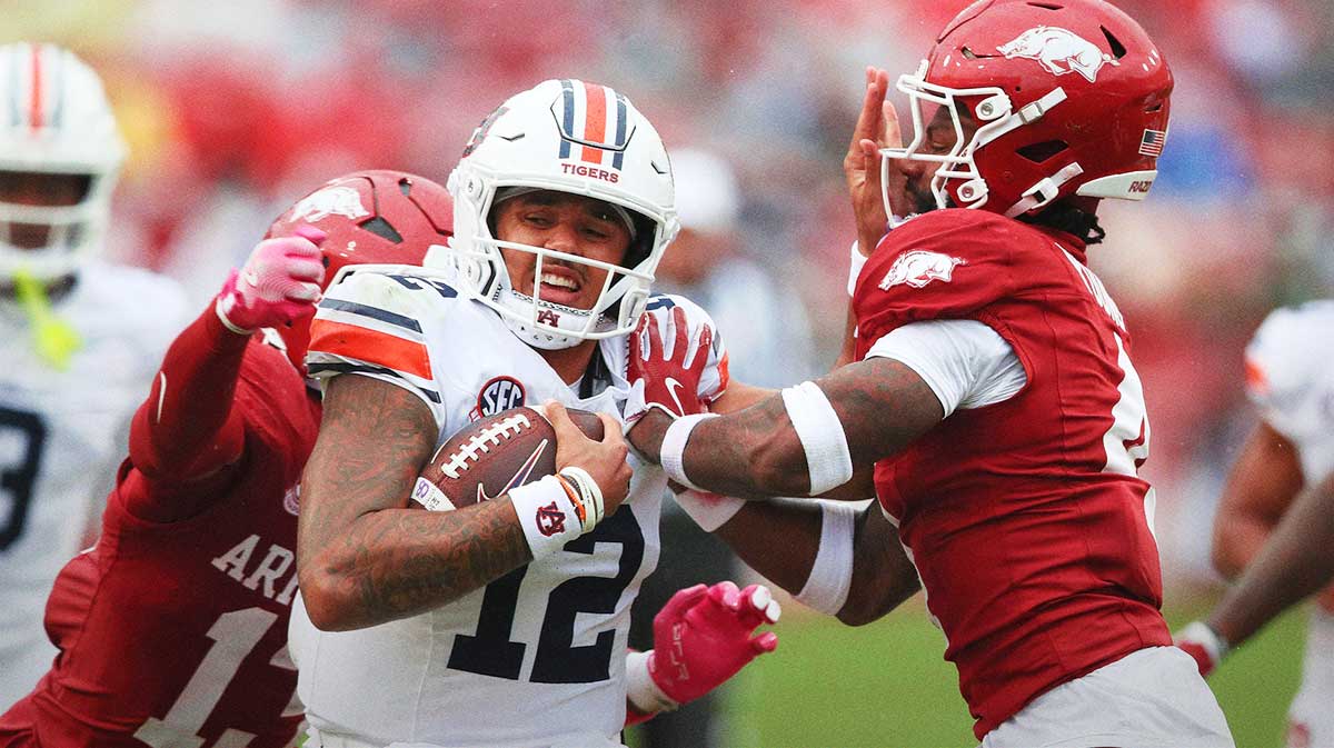 Auburn Tigers quarterback Ashton Daniels (14) rushes during the third quarter against the Arkansas Razorbacks at Donald W. Reynolds Razorback Stadium.