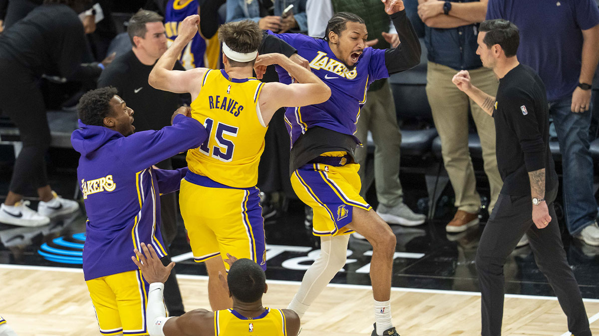 Los Angeles Lakers guard Austin Reaves (15) celebrates with guard Bronny James (9) and guard Nick Smith Jr. (20) after making a buzzer beater shot against the Minnesota Timberwolves at Target Center.