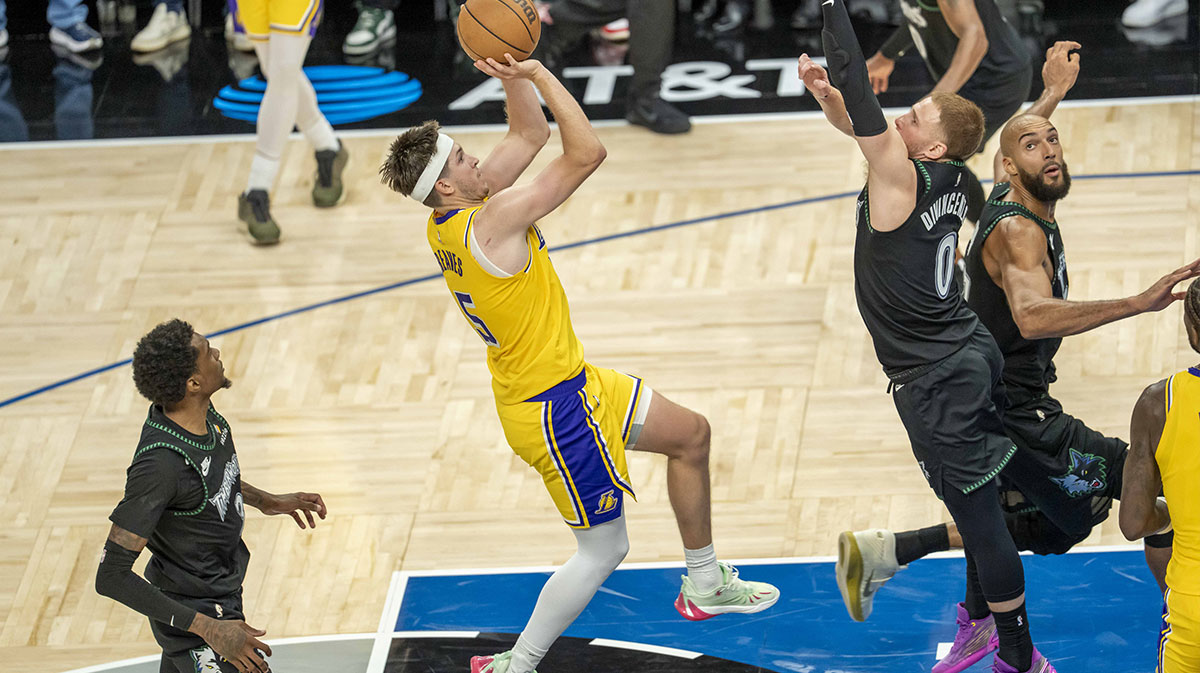 Los Angeles Lakers guard Austin Reaves (15) shoots a game winning shot over Minnesota Timberwolves guard Donte DiVincenzo (0) in the second half at Target Center.