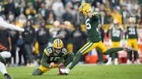 Green Bay Packers kicker Lucas Havrisik (35) kicks a field goal with punter Daniel Whelan (19) in the fourth quarter against the Cincinnati Bengals at Lambeau Field.
