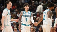 Charlotte Hornets guard LaMelo Ball (1) celebrates with center Ryan Kalkbrenner (11) and forward Miles Bridges (0) against the Washington Wizards during the fourth quarter at Capital One Arena.