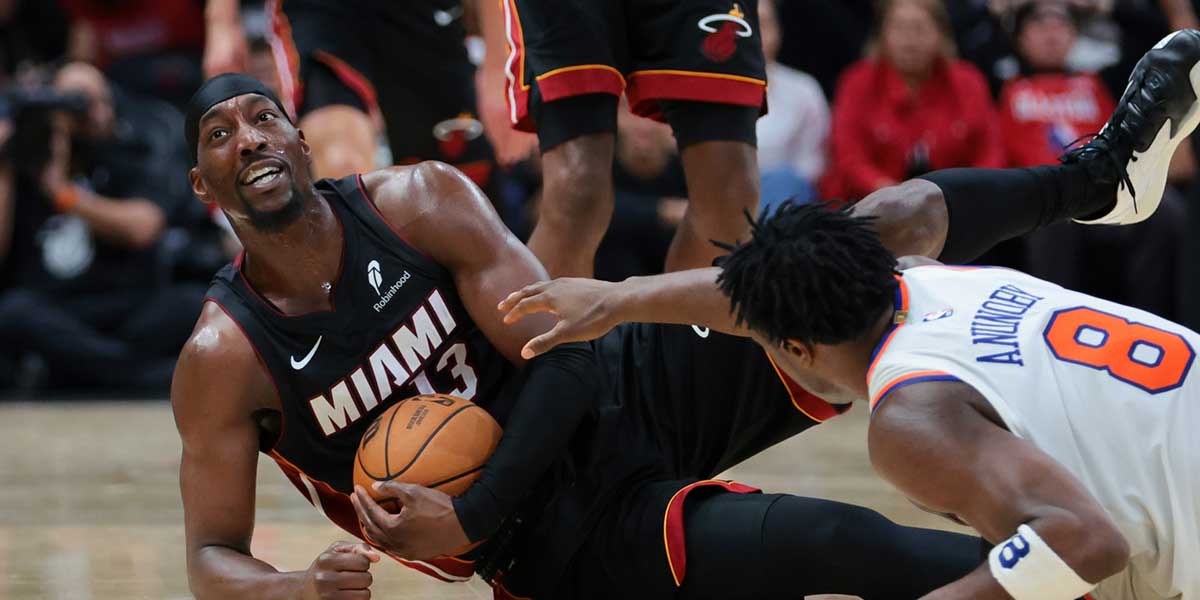 Miami Heat center Bam Adebayo (13) recovers a loose ball against New York Knicks forward OG Anunoby (8) during the fourth quarter at Kaseya Center.