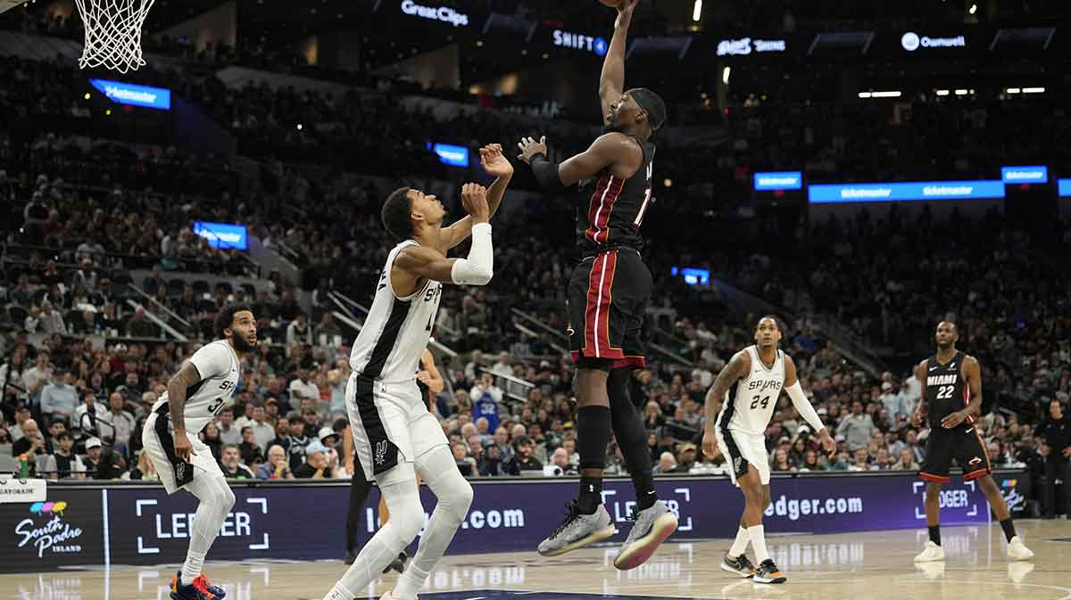 Miami Heat forward Bam Adebayo (13) shoots over San Antonio Spurs forward Victor Wembanyama (1) during the second half at Frost Bank Center.