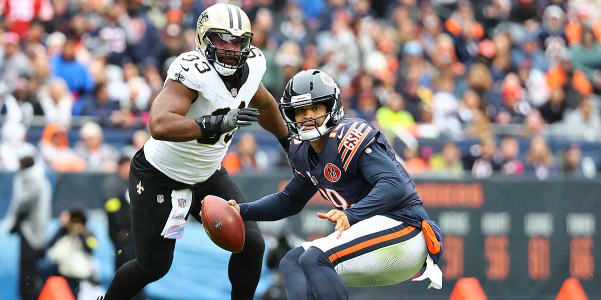 Chicago Bears quarterback Caleb Williams (18) rushes the ball against the New Orleans Saints during the second quarter at Soldier Field