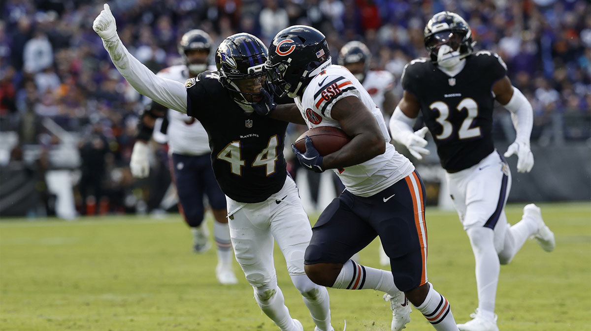 Chicago Bears running back D'Andre Swift (4) runs with the ball as Baltimore Ravens cornerback Marlon Humphrey (44) attempts a tackle in the fourth quarter at M&T Bank Stadium