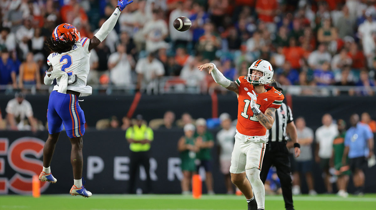 Miami Hurricanes quarterback Carson Beck (11) passes the football as Florida Gators defensive back Lagonza Hayward (2) attempts a block during the fourth quarter at Hard Rock Stadium.