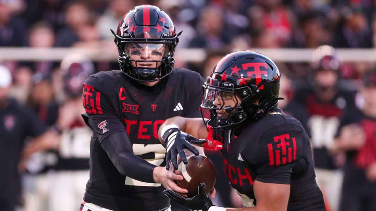 Texas Tech's Behren Morton hands off to Cameron Dickey during a Big 12 Conference football game, Saturday, Oct. 11, 2025, at Jones AT&T Stadium in Lubbock.