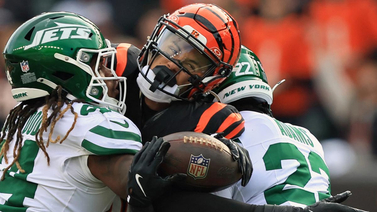Cincinnati Bengals wide receiver Andrei Iosivas (80) tries to escape attack from New York Jets linebacker Jamien Sherwood (44) and safety Tony Adams (22) during the fourth quarter at Paycor Stadium.
