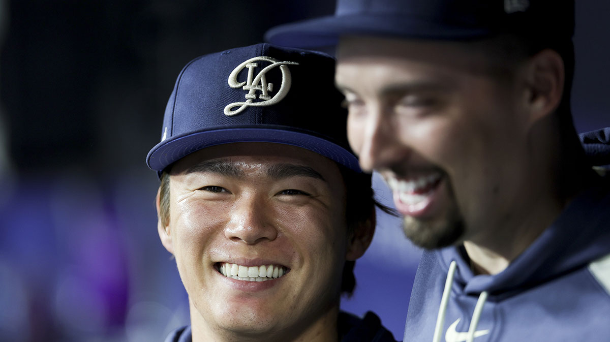 Jun 14, 2025; Los Angeles, California, USA; Los Angeles Dodgers starting pitchers Yoshinobu Yamamoto, left, and Blake Snell laugh during the seventh inning of a baseball game against the San Francisco Giants at Dodger Stadium. Mandatory Credit: Ryan Sun-Imagn Images
