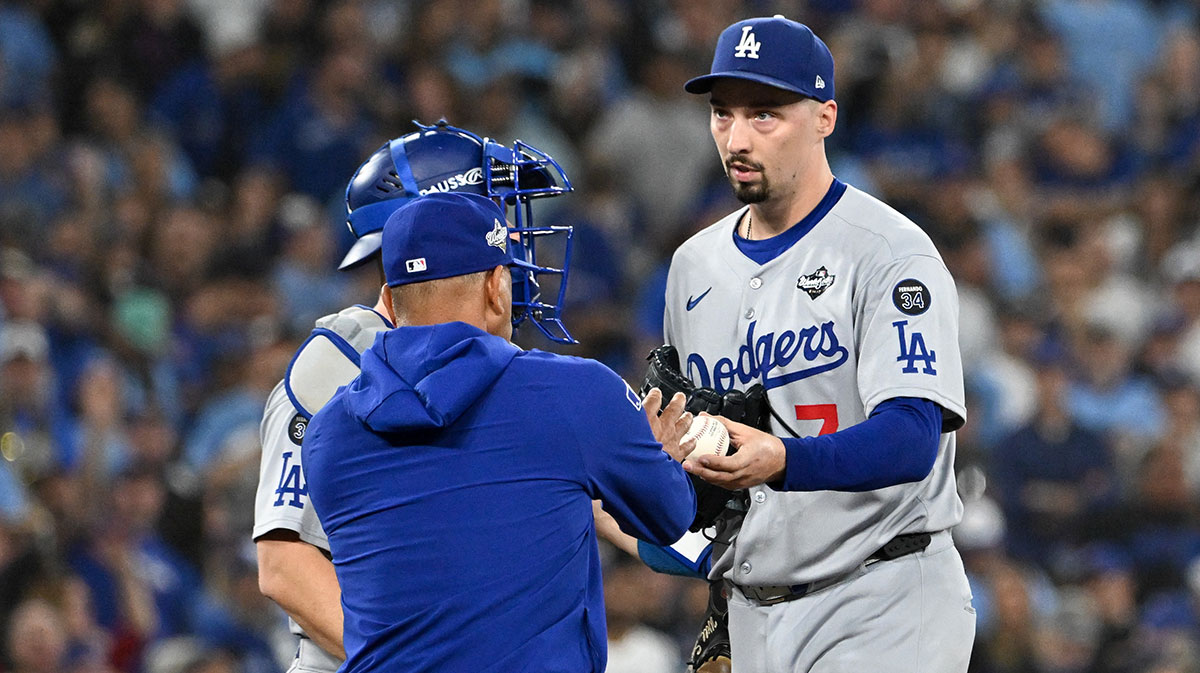 Los Angeles Dodgers manager Dave Roberts (30) takes the ball from pitcher Blake Snell (7) in the sixth inning during game one of the 2025 MLB World Series against the Toronto Blue Jays at Rogers Centre.