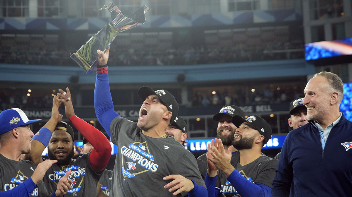 Toronto Blue Jays designated hitter George Springer (4) celebrates with the trophy after defeating the Seattle Mariners in game seven of the ALCS round for the 2025 MLB playoffs at Rogers Centre.